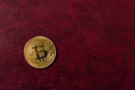 Gold bitcoin coin on leather background. cryptocurrenciesの写真素材