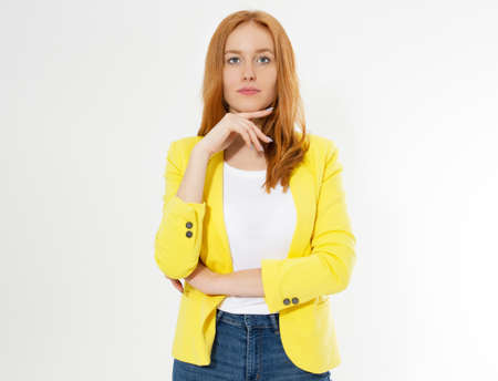Happy beautiful young red head woman in a stylish yellow jacket copy space. Attractive red hair girl looking at camera.の写真素材