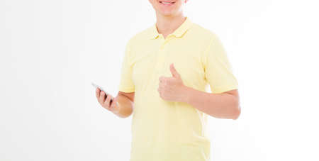 man in t-shirt holding cell phone and shows a hand like. Arm holdin smartphone. Copy space