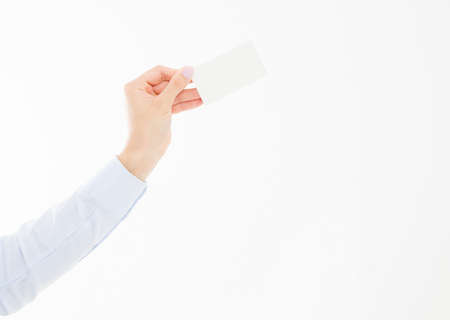 female hand holding business card isolated on white background. copy space