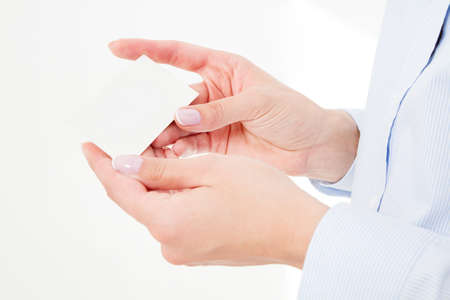 female hand holding business card isolated on white background. copy space