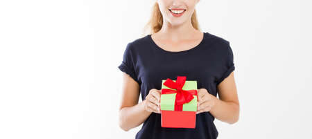 cropped portrait of a smiling girl, woman holding stack of gift boxes isolated on white background....