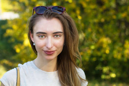 Close up happy Woman smiling with perfect smile and white teeth in a park and looking at camera