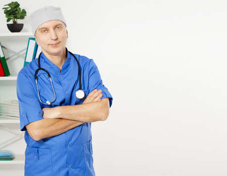 Portrait Of A Confident Mature Doctor Looking At Camera Isolated On Medical Office Background.の写真素材