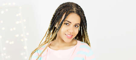Portrait young black woman with afro hair. gray background