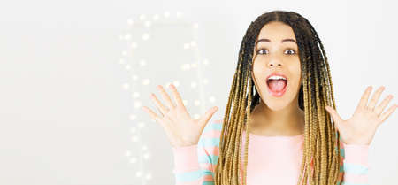 Emotional beautiful woman with hand up on blurred bokeh background isolated.の写真素材