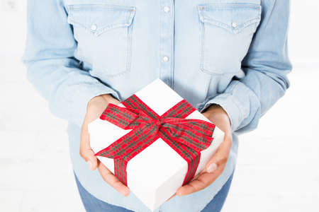 gift box in woman's hands on white backgroundの写真素材