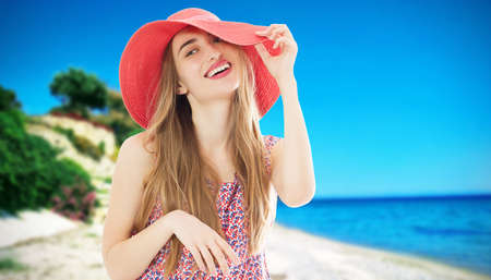 Young and beautiful woman in hat on a sunny day sea and beach