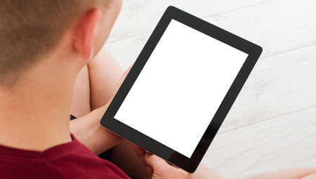 man watching something on her tablet at home