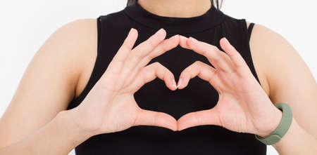 girl shows a heart-shaped gesture close-up. love theme.Top view. Mock up. copyspace. template....