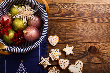 Frame of Christmas accessories and cookies on brown wooden background. top view. copy space and mock...