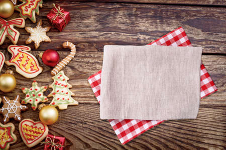 Christmas, New Year Background. Xmas wooden table with cookies and tablecloth, napkin. Top view, copy space, mockupの写真素材