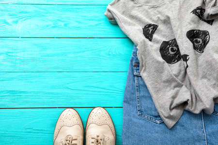Female outfit on blue wooden background. top viewの写真素材