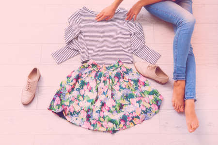 Stylish outfit with female body parts on white wooden floor. top viewの写真素材