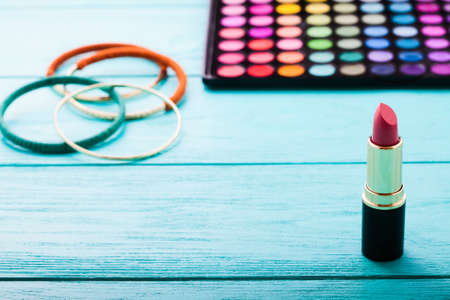 Cosmetics and accessories on blue wooden background. top viewの写真素材