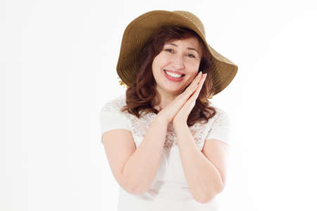 Happy woman in summer hat isolated on white background. Sun protection skin care and vacation holidays concept. Middle age female with white teeth healthy and menopause. travel holiday. copy spaceの写真素材