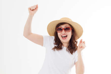Happy surprised and excited woman in summer hat, sunglasses and template white t shirt isolated on white background. Holiday vacation with big sale. fun summertime. Copy space, blank place on tshirt.の写真素材