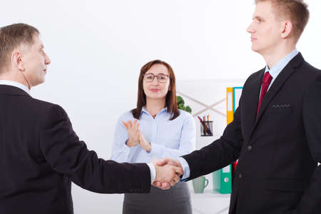 Successful business partnership concept with businessmans handshake. Happy businesswoman applause at office background. Team work businessmen handshaking after profitable deal. selective focus. Bannerの写真素材