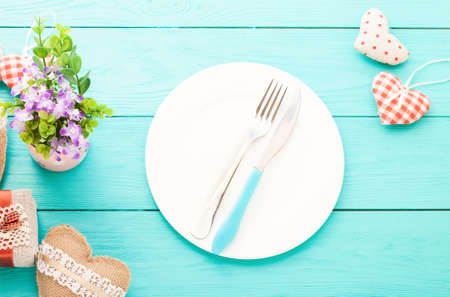 Valentines day set with silverware. Valentine day love beautiful. Romantic dinner, tableware and hearts on wooden background.Top view.の写真素材