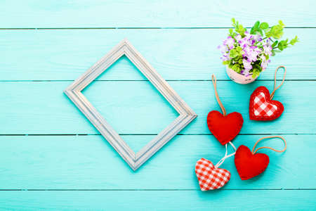Romantic frame with copy space and accessories on blue wooden background.の写真素材