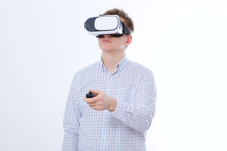 Young business man in vr glasses, goggles watching virtual reality isolated on white background....
