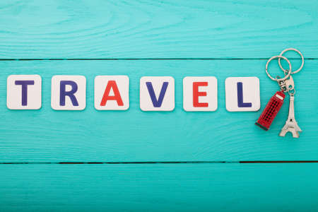tourism concept. Word travel with trinket on blue wooden background. copyspace. top view. Mock upの写真素材