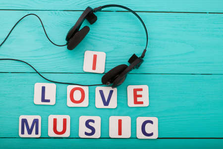 Phrase I love music on blue wooden background. top view and copy space