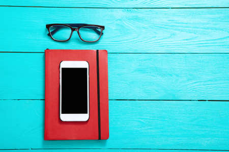 Workplace with hipster accessories on blue wooden background. top view