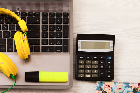 Workplace woth keyboard, headphones for music, calculstor and copy space. White wooden desk. top voew. business conceptの写真素材
