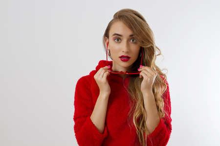 Closeup woman face with red lips, sunglasses hoodie isolated on white background. Fashionable girl...