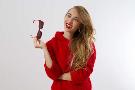 Happy, shock, excited woman face closeup. Girl in bright red hoodie autumn clothes red sunglasses...