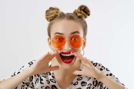 Shouting woman face. Fashion female closeup in trendy clothes isolated on white background. Summer...