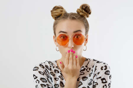 Close-up woman face. Fashion female closeup in trendy clothes isolated on white background. Summer fun time and summertime accessories. Funny girl.の写真素材