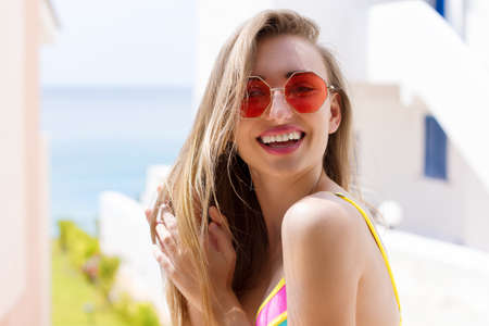 Close Up Of Happy Girl in pink sunglasses. Summer holidays and fun time weekend. summertime concept. Smiling young woman in fashion swimsuit. selective focus. Beach summer outfit. copy spaceの写真素材