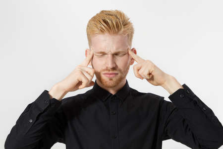 Young man thinking process. Close up redheaded guy with red beard in black shirt focus on creating...