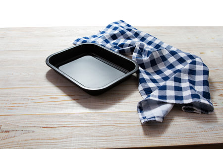 empty tray for baking food and tablecloth on wooden background mockup