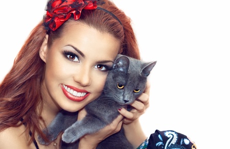 close up portrait of a pretty girl with a catの写真素材