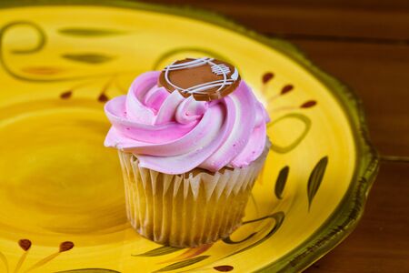 Close up of a cup cake on the wooden tableの写真素材