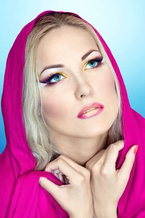 Pretty girl with colorful makeup looking upの写真素材