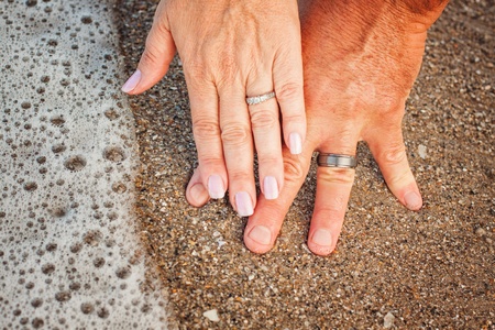 Close up picture of holding hands and engagement ringの写真素材