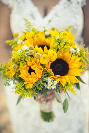 Close of the the bride holding her flowers, bridal bouquet at the weddingの写真素材