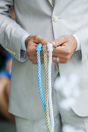 Close up of a Wedding tradition tighting the knotの写真素材