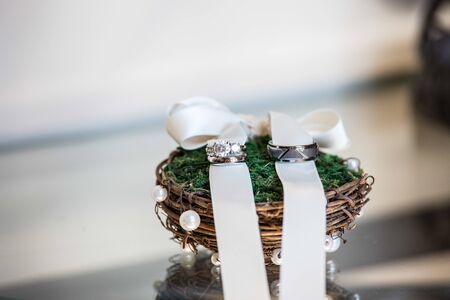 Wedding ring bands on a rustic ring holderの写真素材