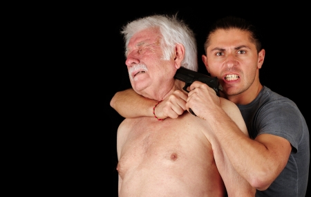 Terrorist with gun and old man の写真素材