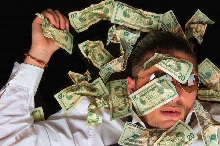 Man covered with US dollars,drowning in debt concept