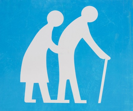 Street sign of old couple crossing the roadの写真素材
