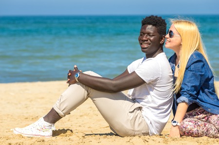 Young woman whispering to her boyfriend 's earの写真素材