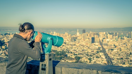 Man photographing San Francisco cityscape from Twin Peaksの写真素材