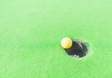 golf ball getting in the holeの写真素材