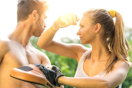 Woman training  self difense martial arts with coachの写真素材